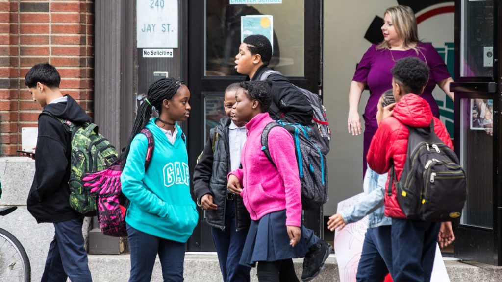 Brooklyn Labs students in New York talk outside the school building
