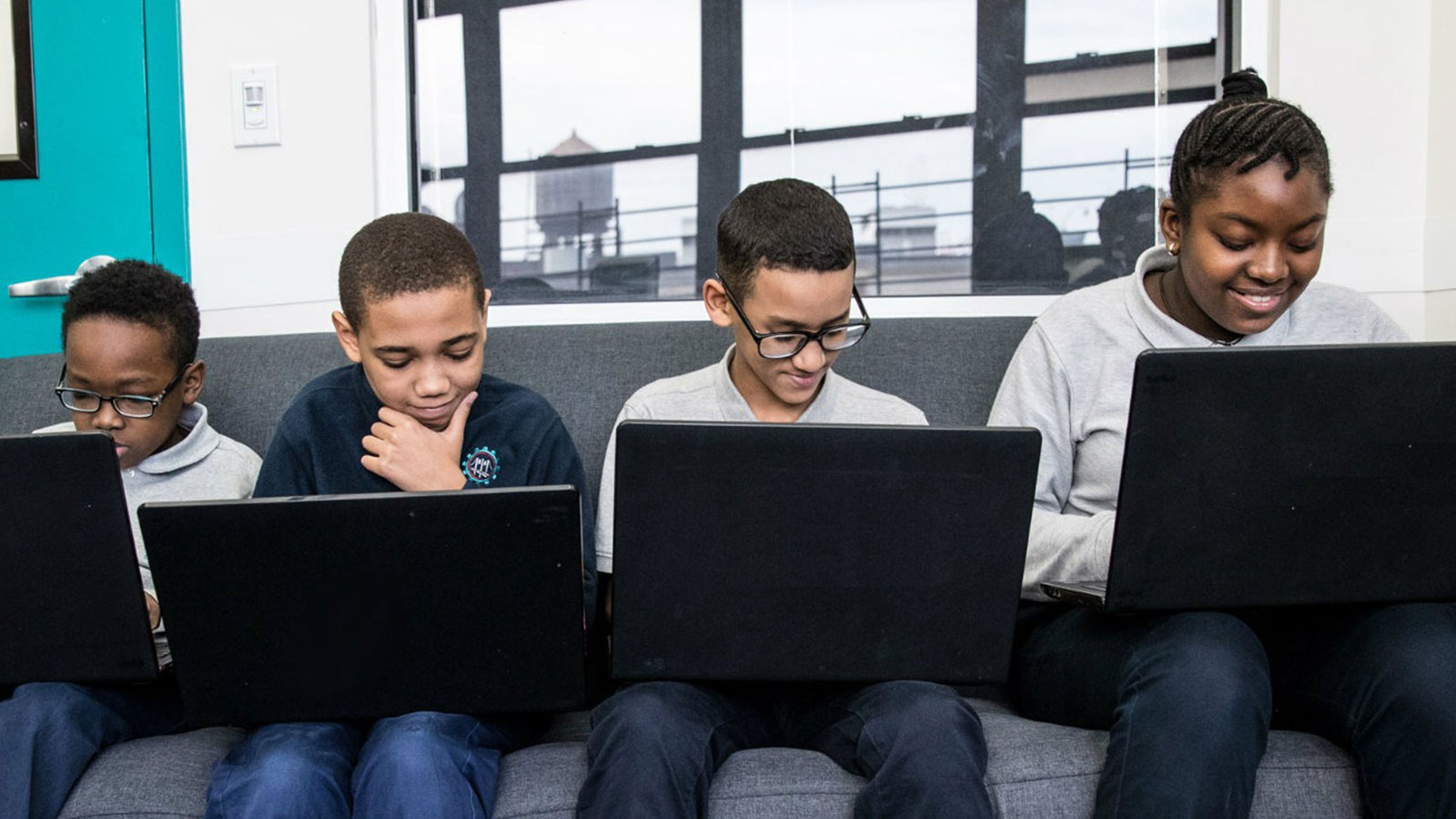 Four students take an assessment on their computers that will inform their teacher's approach thanks to data interoperability