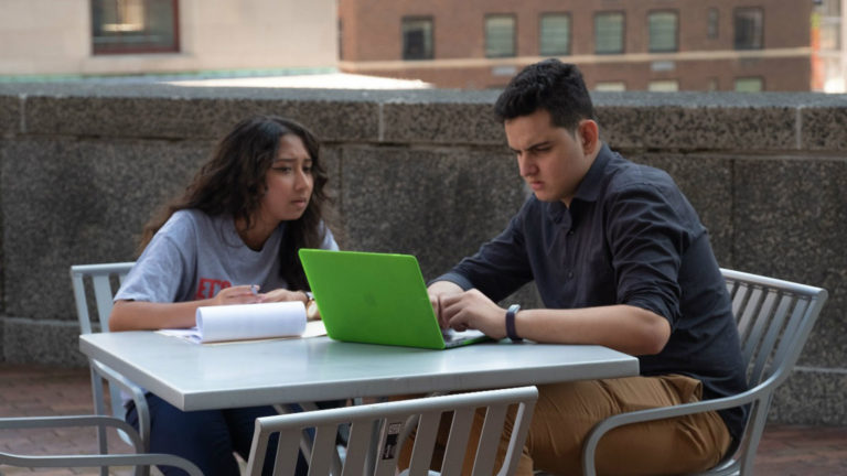 Two college participants of Let's Get Ready study together on a rooftop in New York City