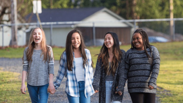 Four girls walking and talking in Central Texas