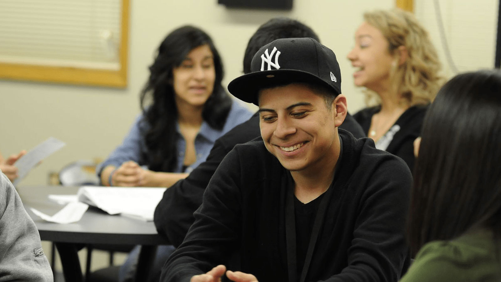 A student talking and smiling to a group