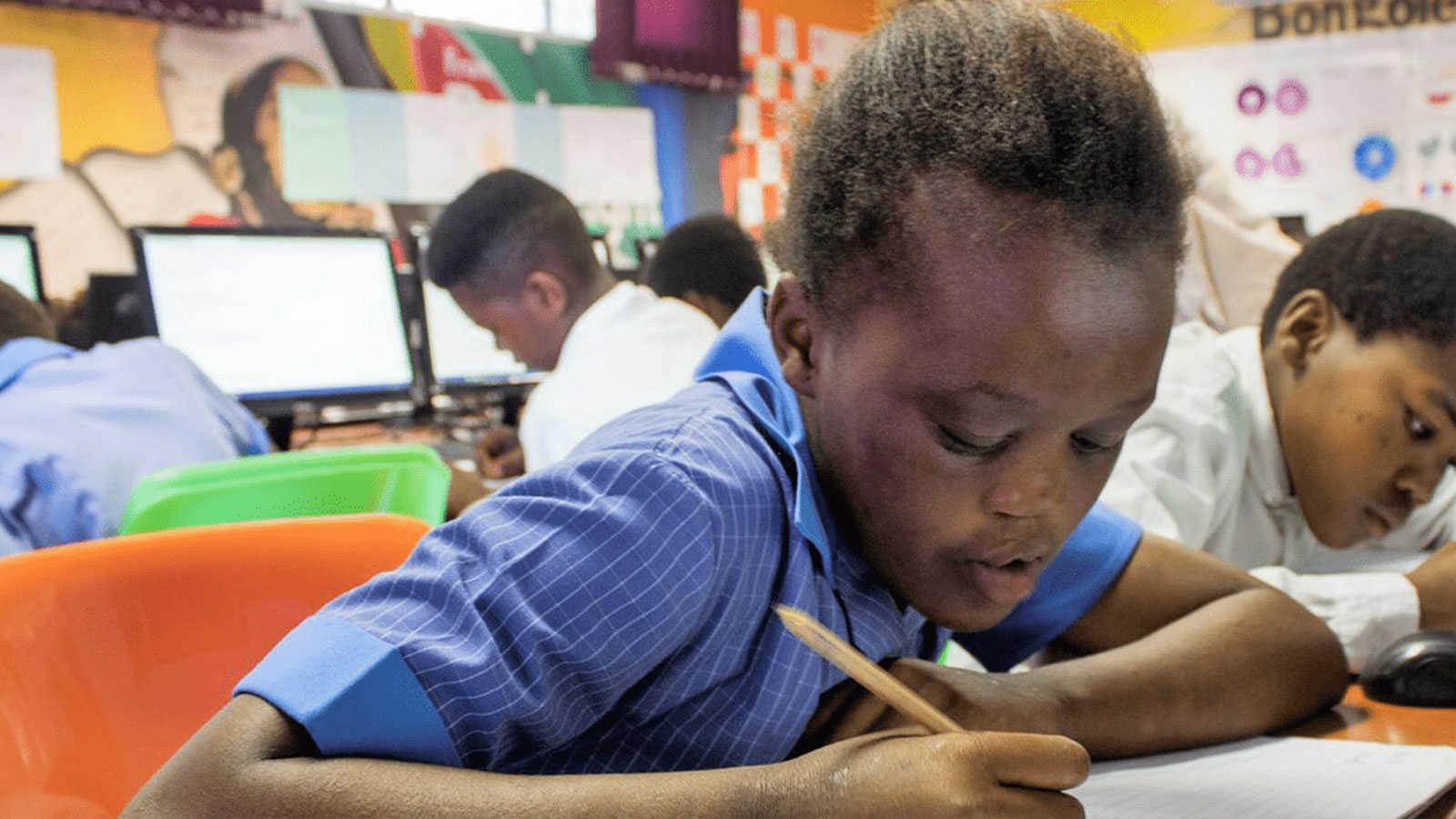 A South African student working on an assignment in a classroom