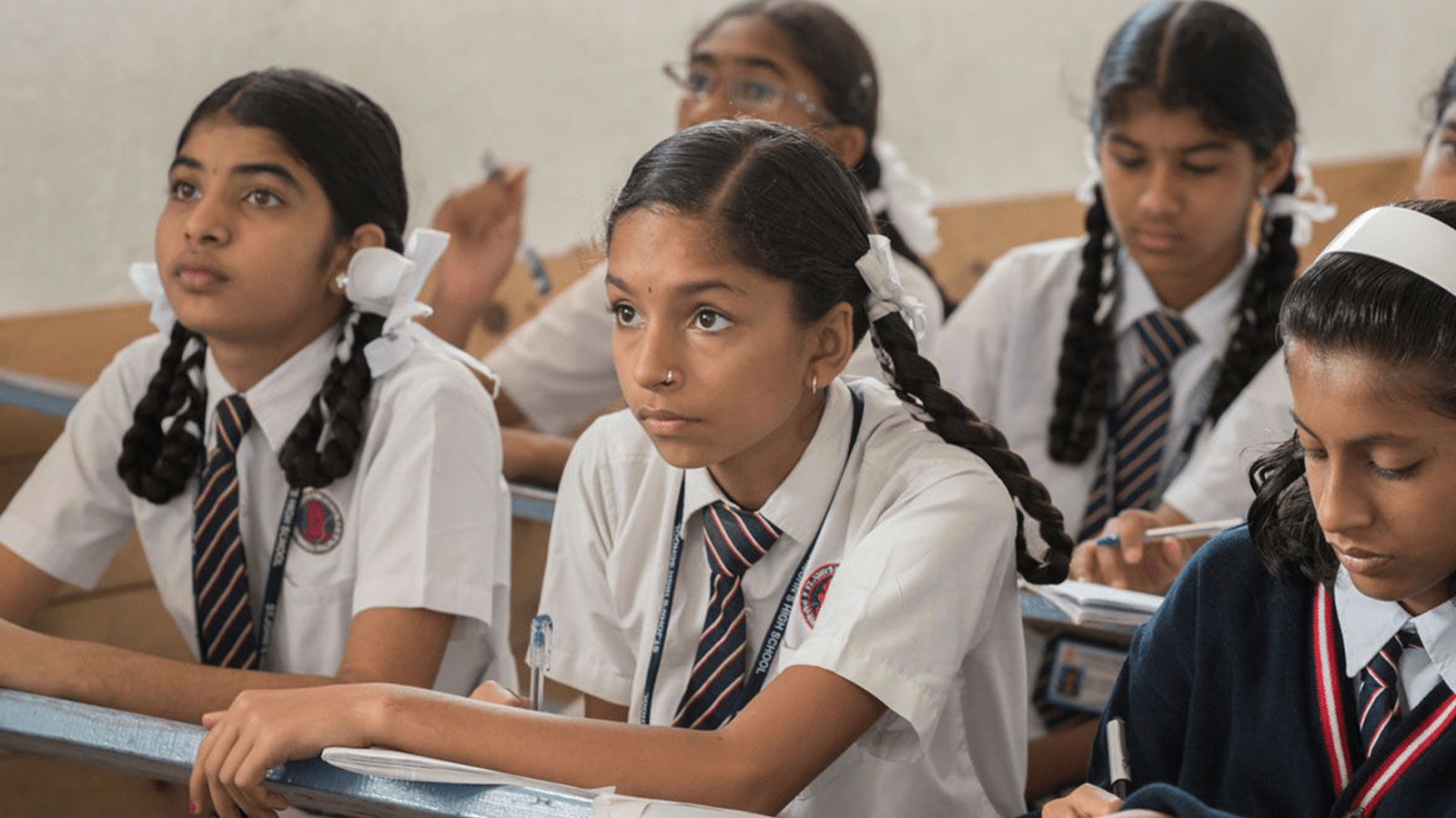 Young girls listening in a classroom