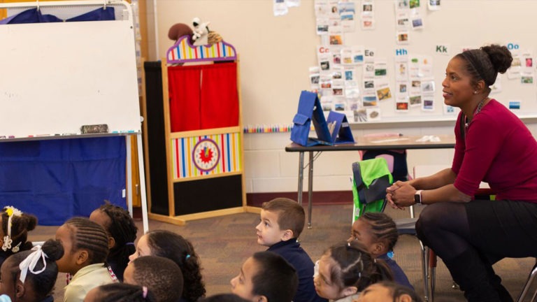 A teacher of the Global Prep Academy watches over her students listening to a guest speaker