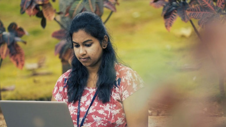 Supreeta, a student in India who received a Foundation for Excellence scholarship, works on her laptop
