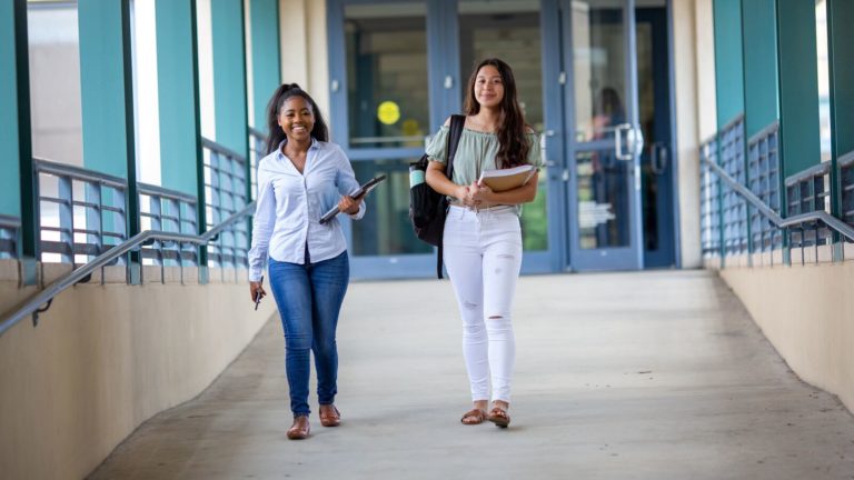 Two college students walk to class