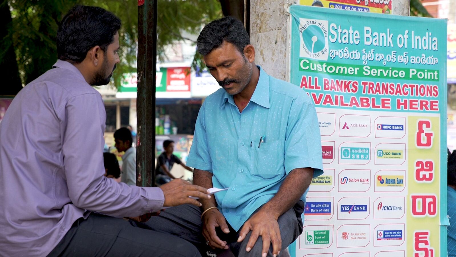 An Indian man signs up for affordable banking services