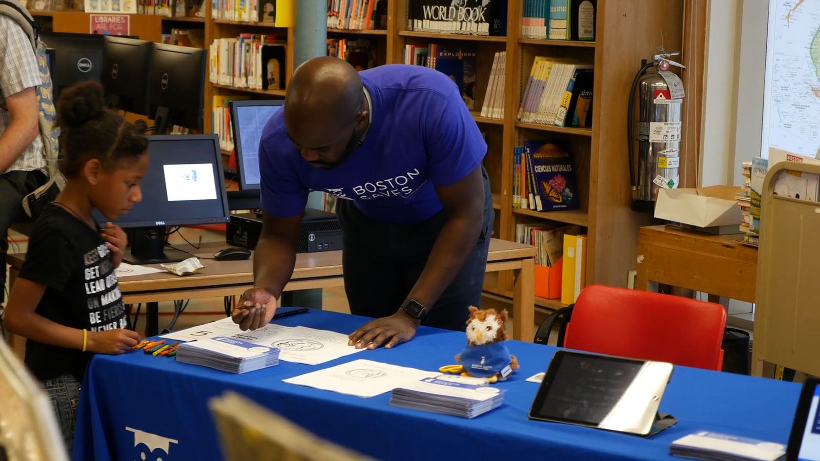 Boston Saves team member working with a young student