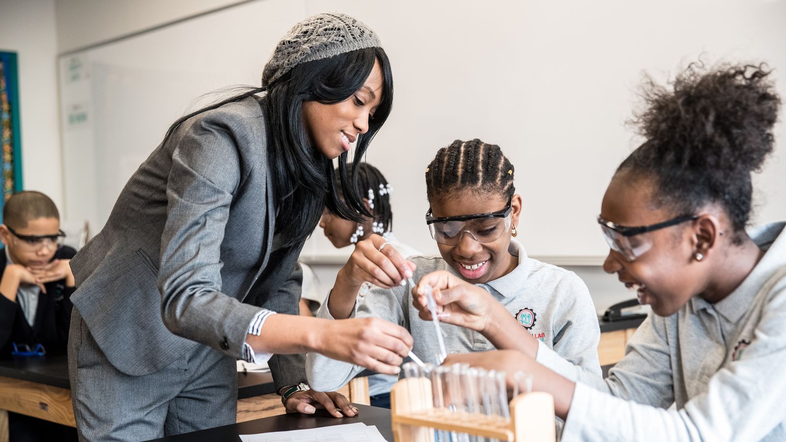 Science teacher with two students in the United States