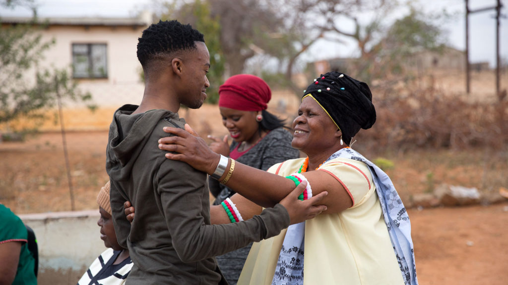 A young South Africa university graduate meets with people in his village.