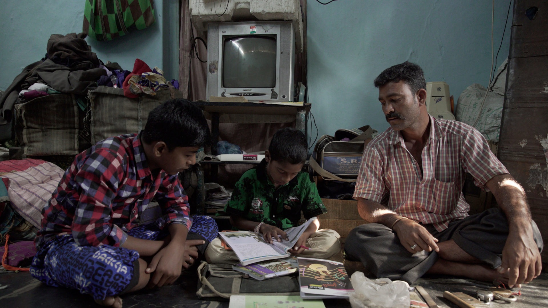 A father in India studying at home with his sons
