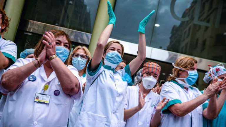 Health care workers stand together in masks