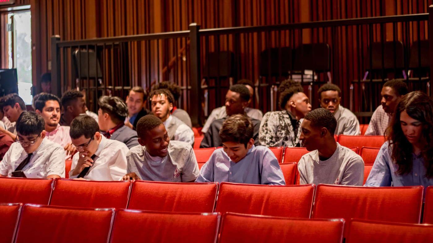 My Brother's Keeper Scholars sit in an auditorium at their annual celebration.