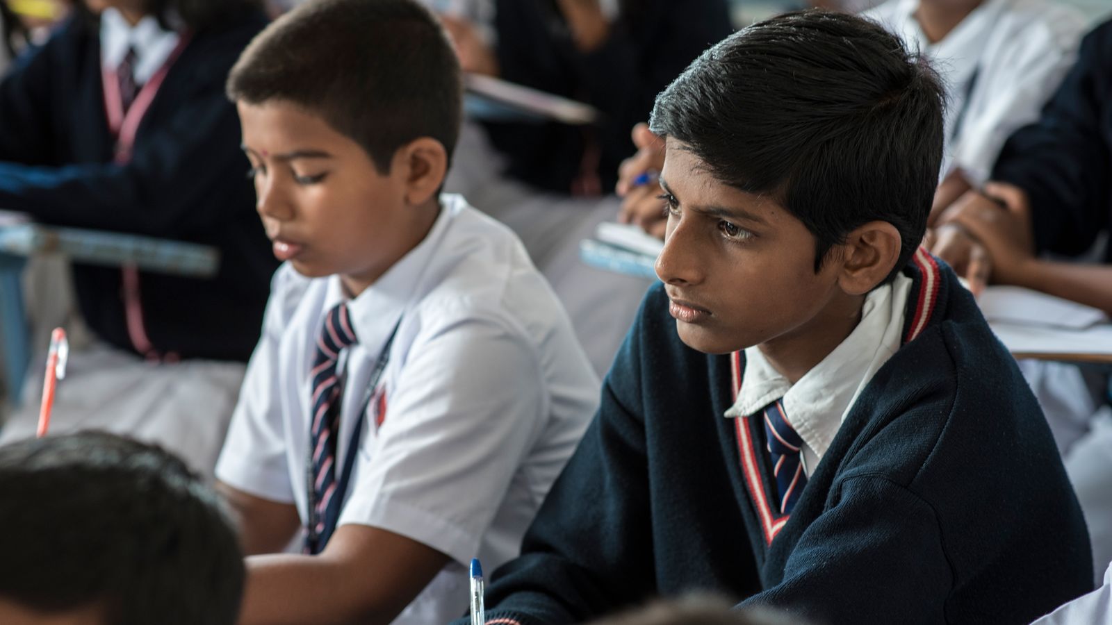 Indian students in the classroom benefit from impact investing