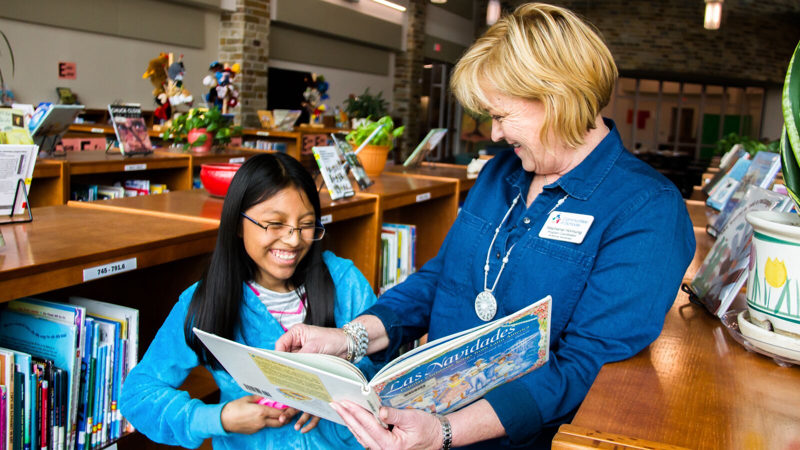 Communities in Schools Program Coordinator Stephanie Hornung reads with her student Keily.