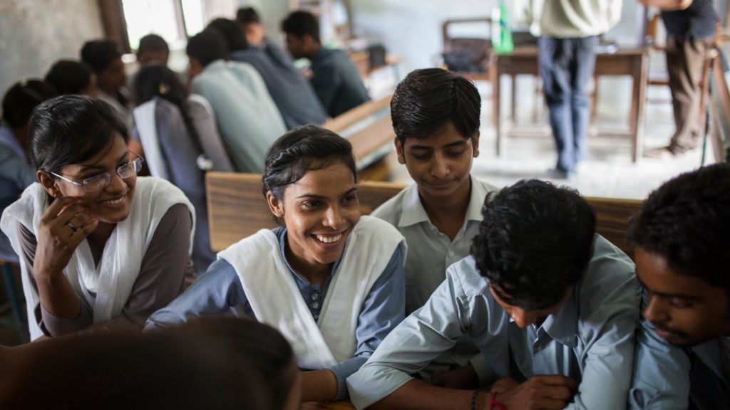 A group of Indian students in class. We're working towards systemic tranformation of schools in India, like theirs.