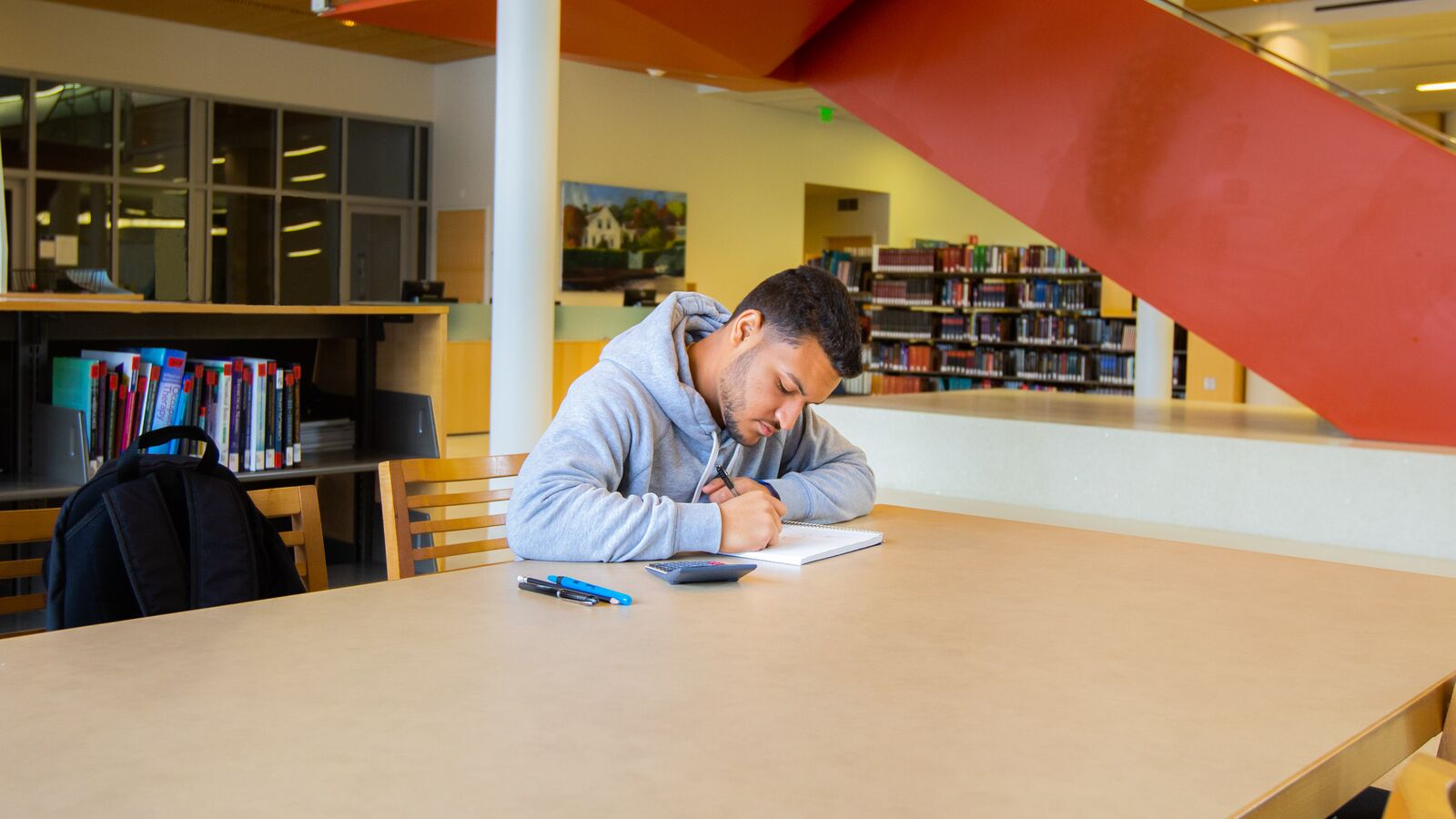 OneGoal student Chris studies at a table