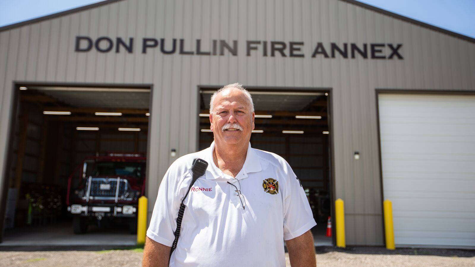 Chief Ronnie Williams stands in front of the new volunteer fire station in Refugio, Texas.