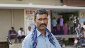 A Sub-K client stands in front of the business in India