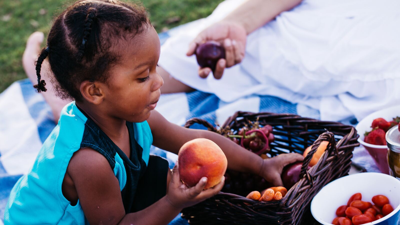 A child enjoys healthy peaches purchased at a farmer's market in Austin