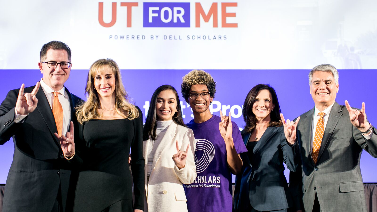 Michael and Susan Dell stand with Dell Scholars and UT Austin president.