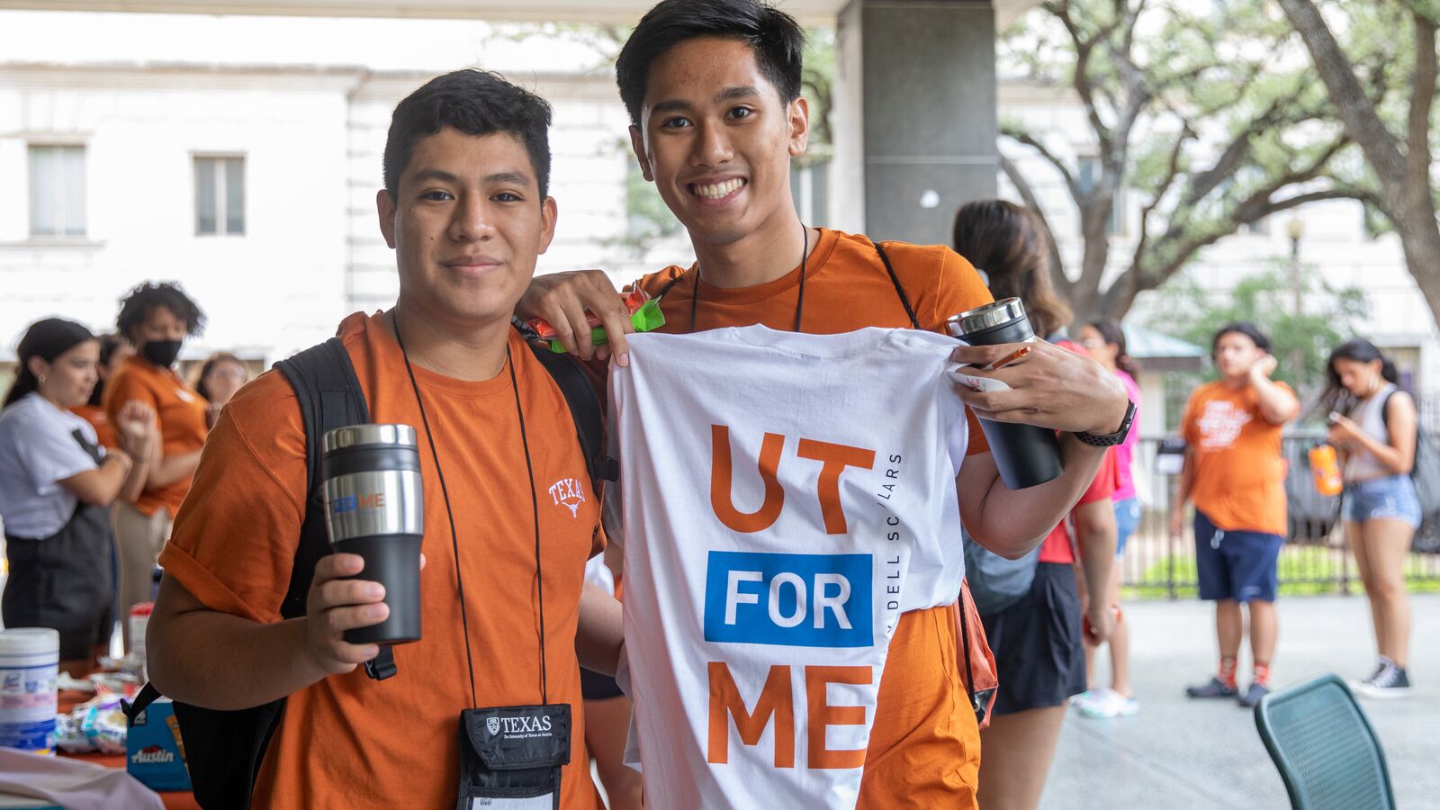 Two smiling young men in UT orange shirts at UT for Me orientation event.