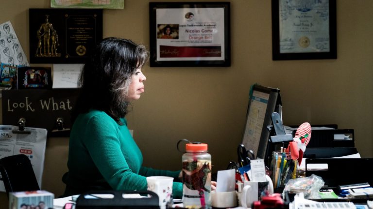 A woman sits in front of her computer