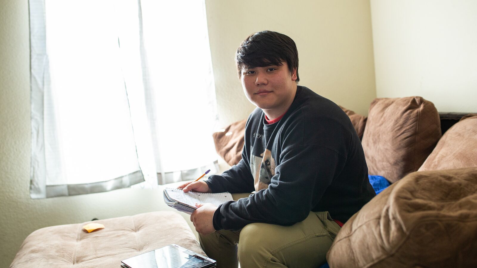 A college student works on assignments at home