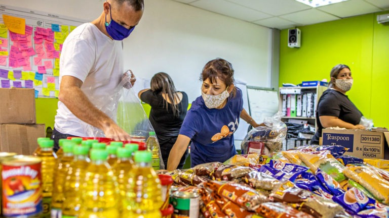 The Clothing Bank team creates food care packages for families living on low incomes during the COVID-19 pandemic