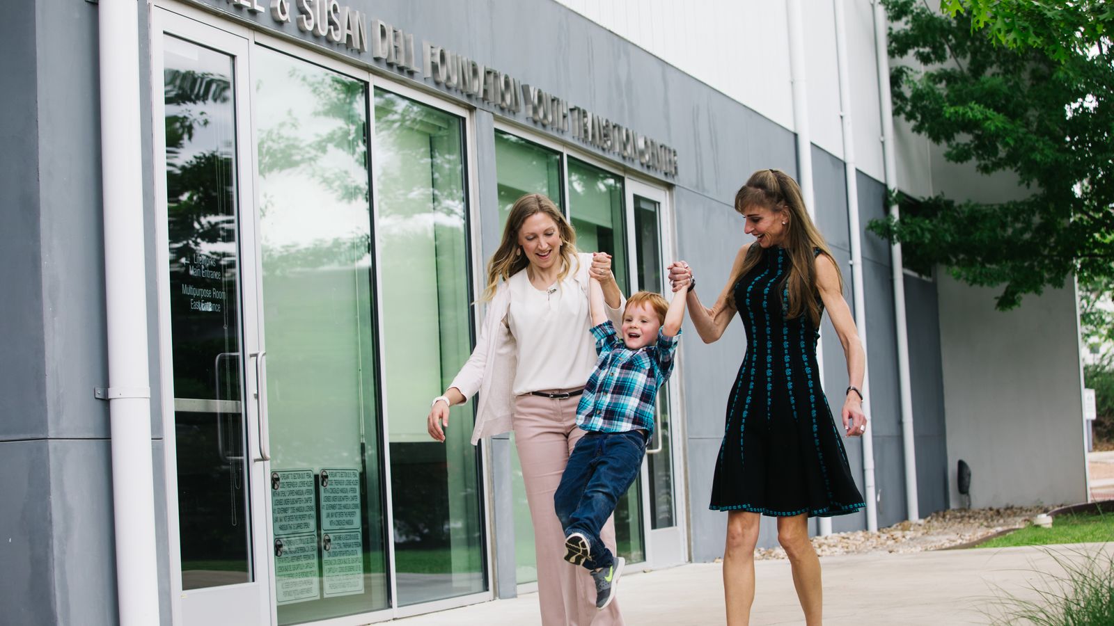 Susan Dell and a foster mom play with a child