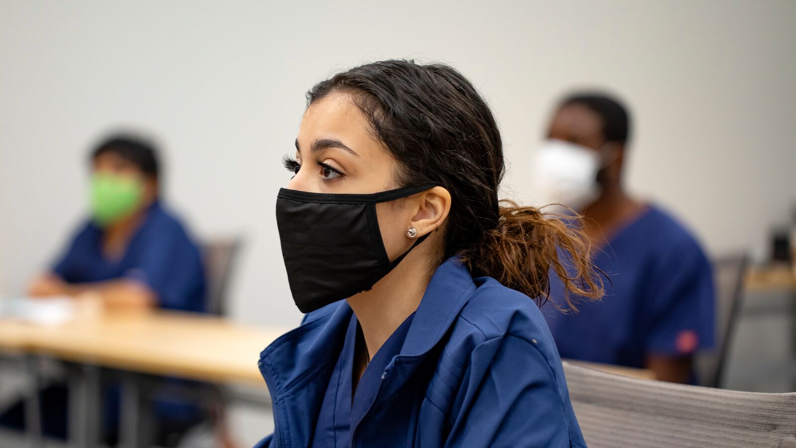 A student at the Central Texas Allied Health Institute attends class in a face mask
