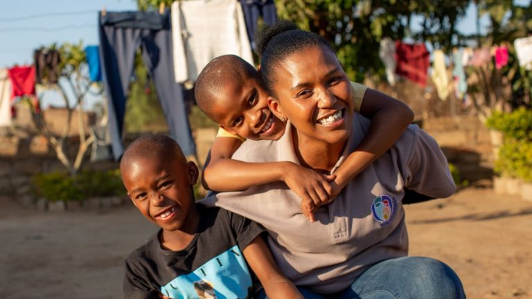 A Mothers2Mothers worker in Africa spends time with her children