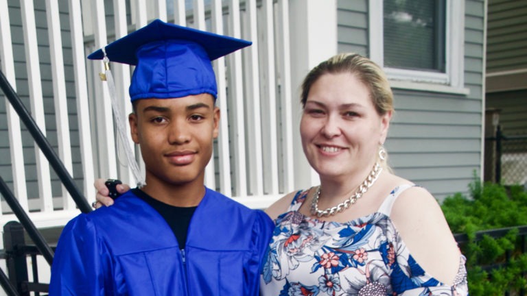 Irene Dunbar, a student of Compass Working Capital, smiles with her son