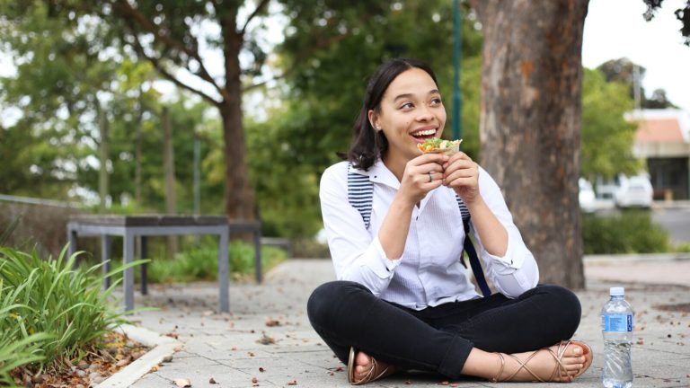 A young woman in South Africa enjoys a healthy lunch