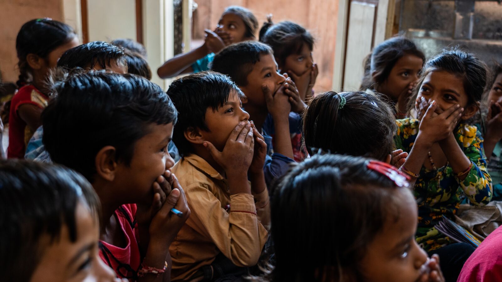 Students studying in a classroom supported through development impact bond funding