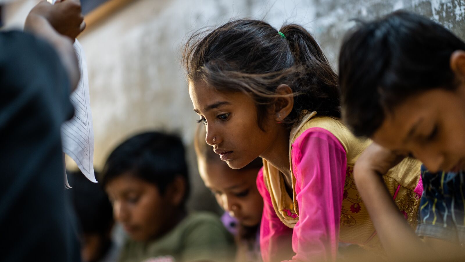 A student studying in a classroom supported through development impact bond funding