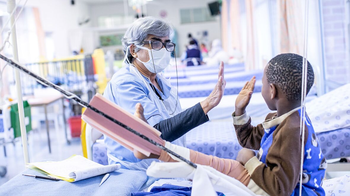 A medical professional at the Red Cross War Memorial Children’s Hospital brings joy to a patient receiving treatment.