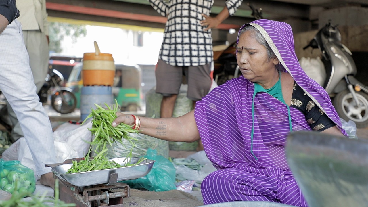 A woman sells vegetables in India