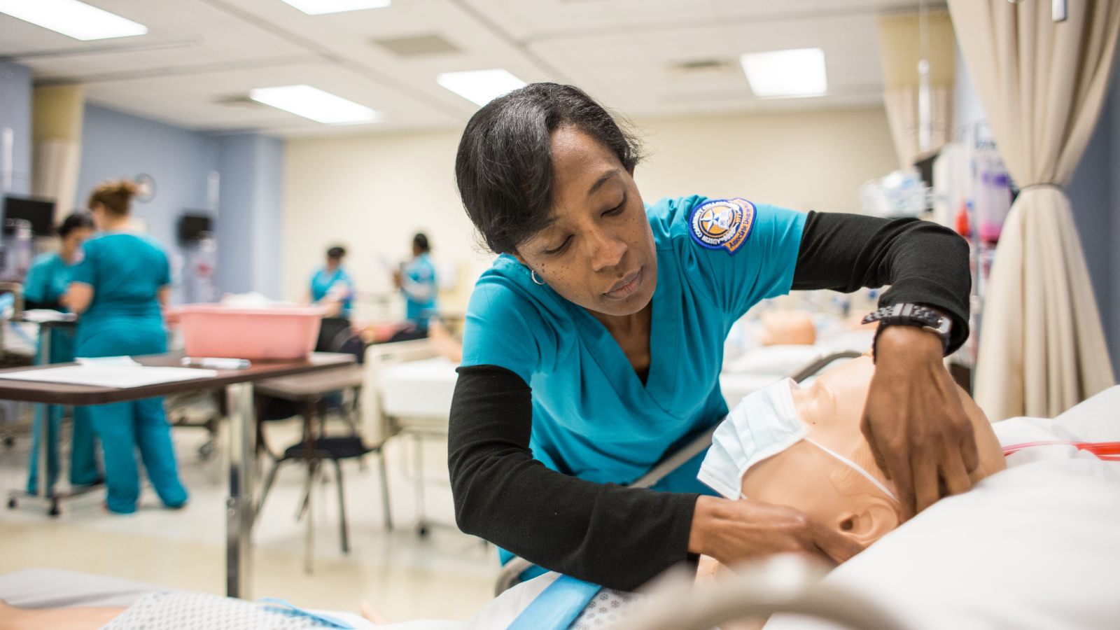 Students studying in ACC's accelerated nursing program practice medical skills