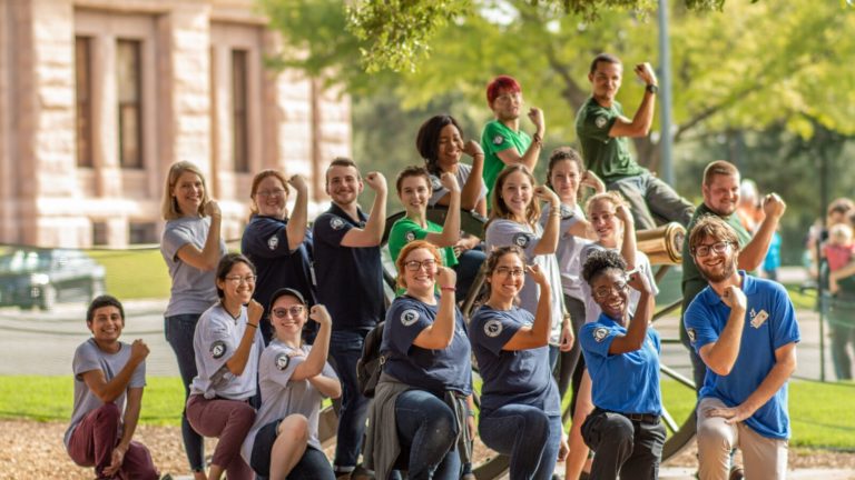 AmeriCorps volunteers standing outside the Texas Capitol