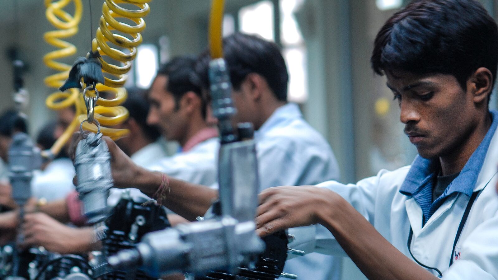Gig workers in India complete tasks in a factory setting