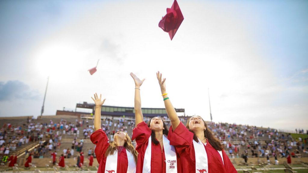 Spring Branch ISD students throw their graduation caps in the air