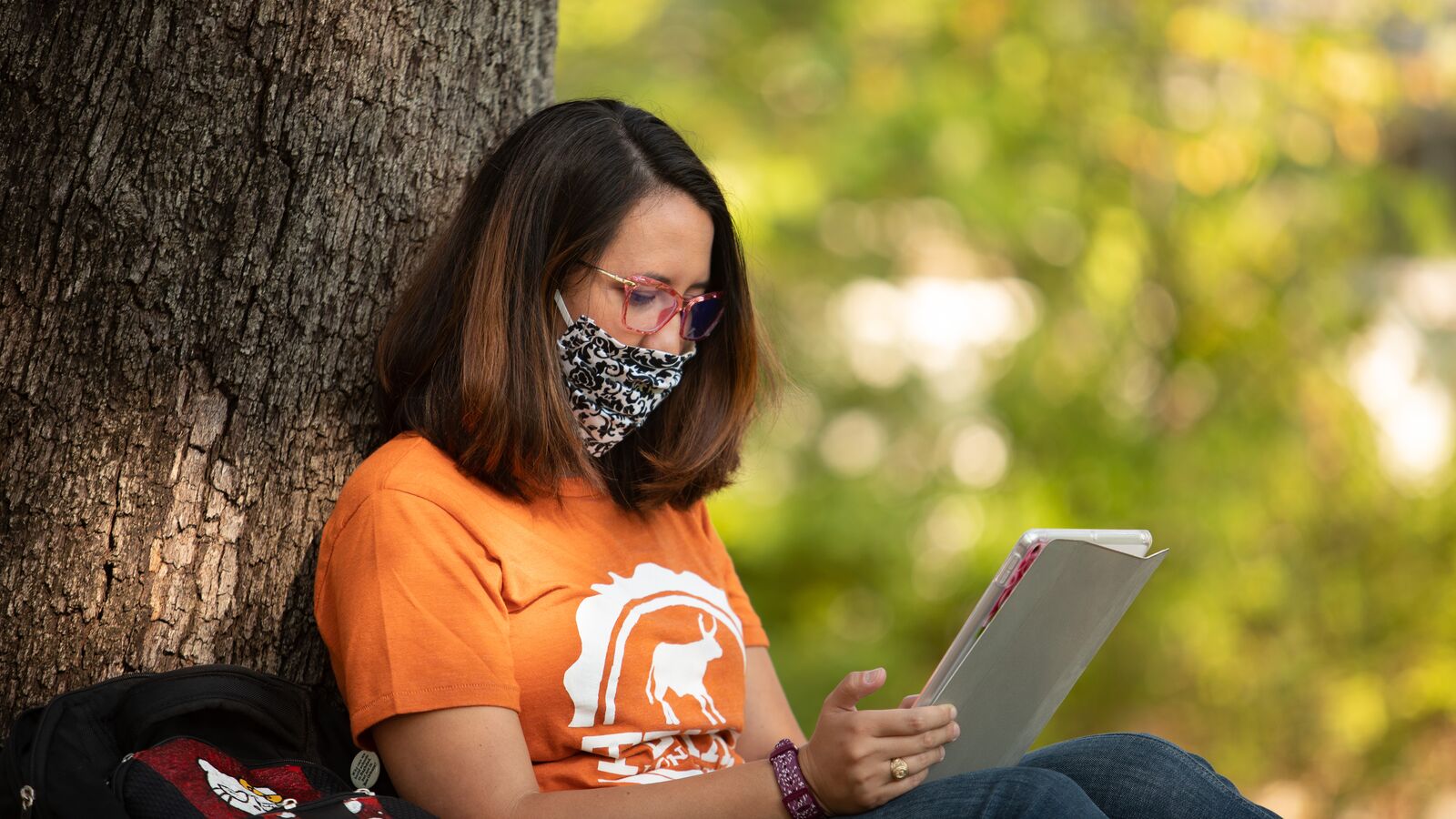 A UT Austin student studies on campus