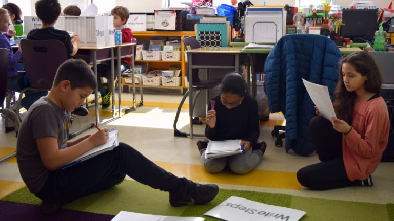 Students practice their writing skills in class at a Rhode Island school