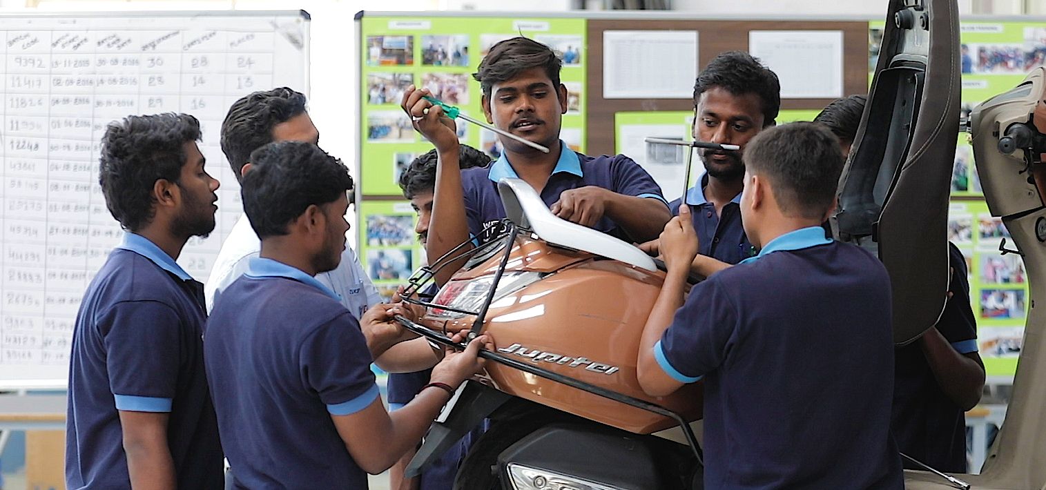 Men in India work on building a motorcycle