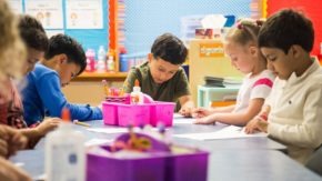 Children coloring at a table in the classroom