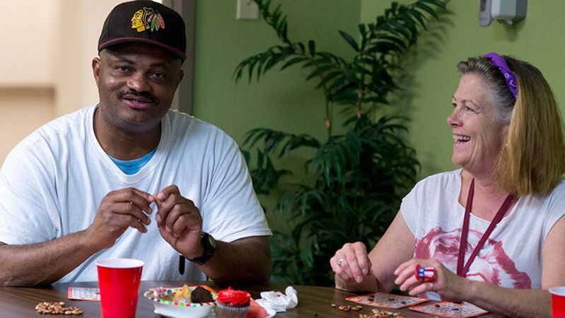 Two people play a game and eat snacks together