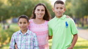 A mother and her two children supported by UpTogether poses outdoors