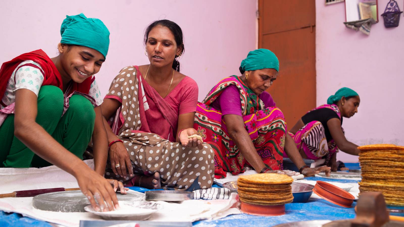 Four women in India making food together