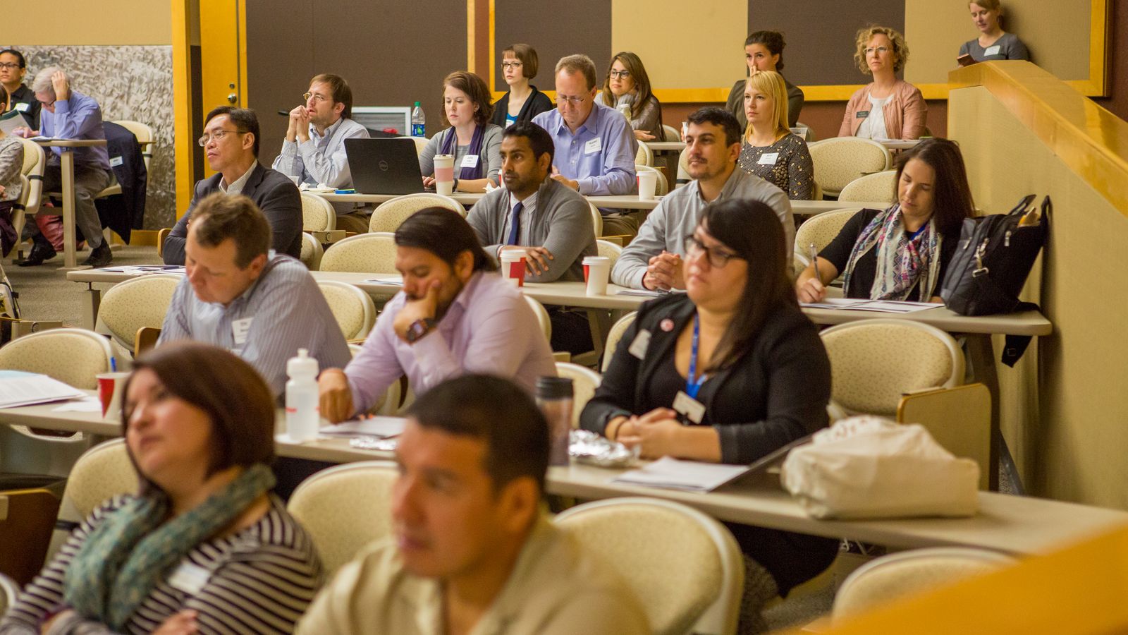 A room of different people viewing a lecture